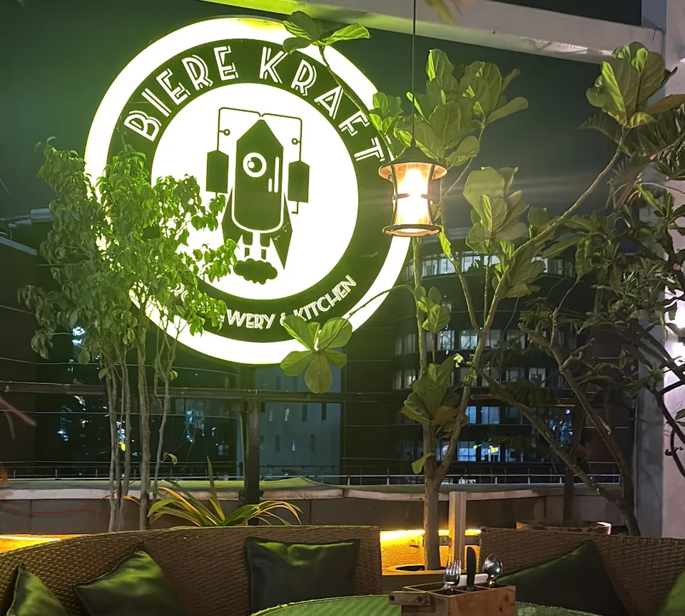 The Biere Kraft logo lit up above the rooftop seating at Biere Kraft Brew & Kitchen